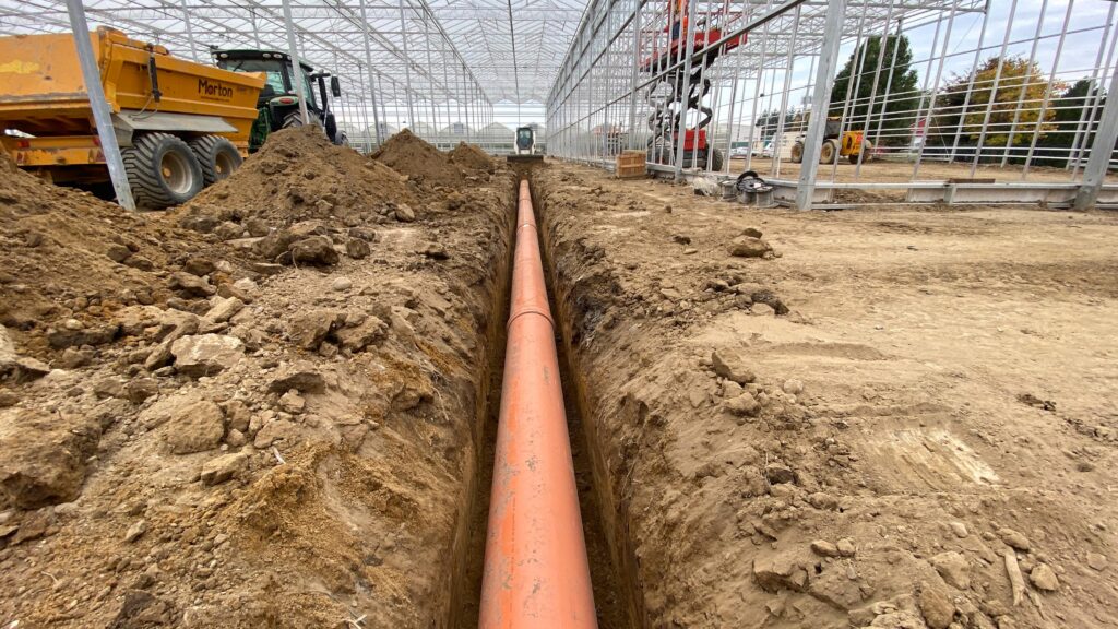 H&A Farms greenhouse construction, laying pipes
